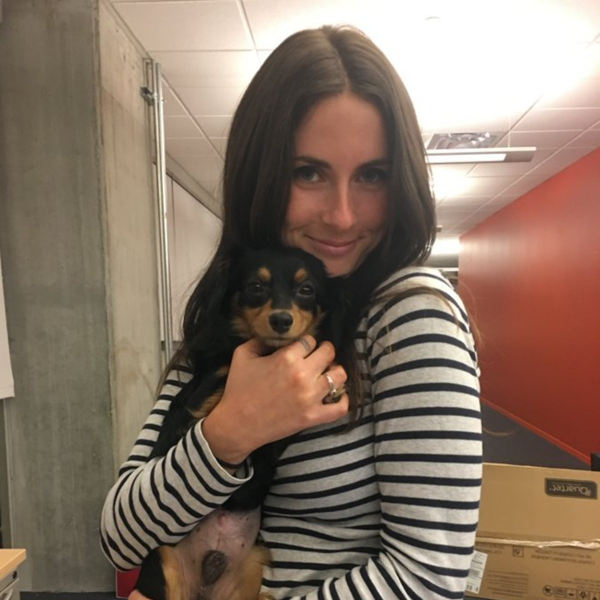 Photo of Rachel Bonnetta while holding her cute dog in her hand. 